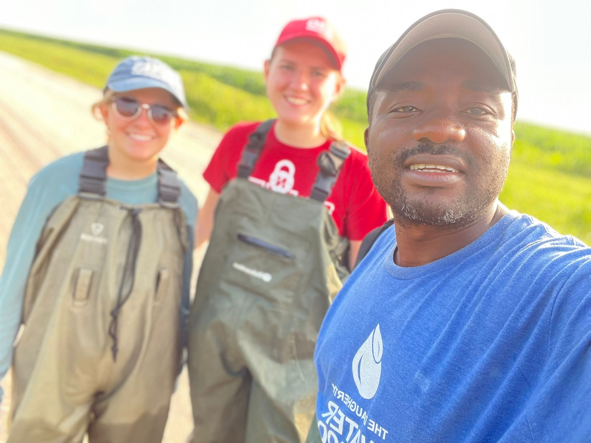 Experiential learning program students smile for a photo before conducting research on tadpoles