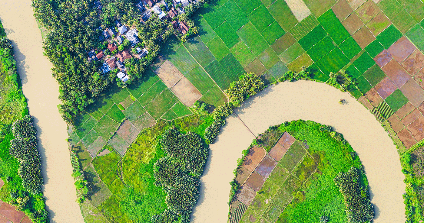 Aerial photo of rural farms, a river, and a community