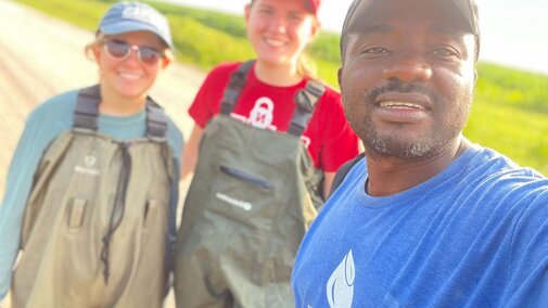 Experiential learning program students smile for a photo before conducting research on tadpoles