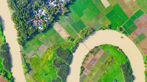 Aerial photo of rural farms, a river, and a community